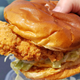 Hand holding Chili's chicken sandwich